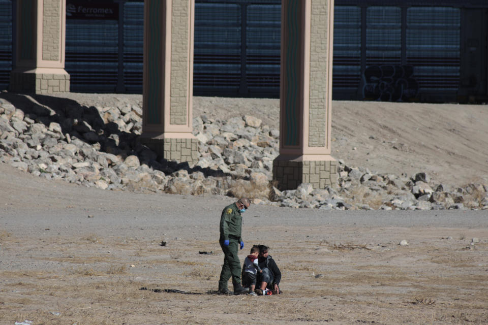 A Central American woman and her son cross the Rio Grande to surrender to the border patrol at the Texas United States crossing. / Credit: Pacific Press