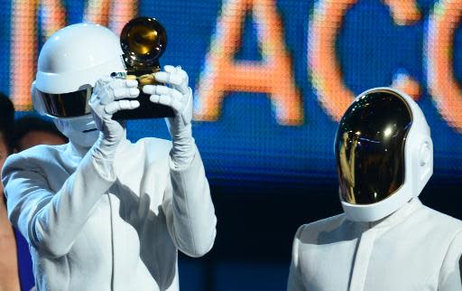 Daft Punk celebrate on stage during the 56th Grammy Awards at the Staples Center in Los Angeles, California, January 26, 2014