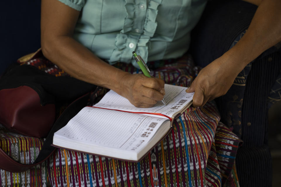 Thelma Cabrera, presidential hopeful for the Movement for the Liberation of the People, MLP, party, writes on a agenda during an interview at her home in El Asintal, Guatemala, Monday, March 13, 2023. Cabrera and the MLP are waiting for the Supreme Electoral Tribunal to approve the candidacy of her running-mate Jordan Rodas, ahead of 2023 general elections. (AP Photo/Moises Castillo)