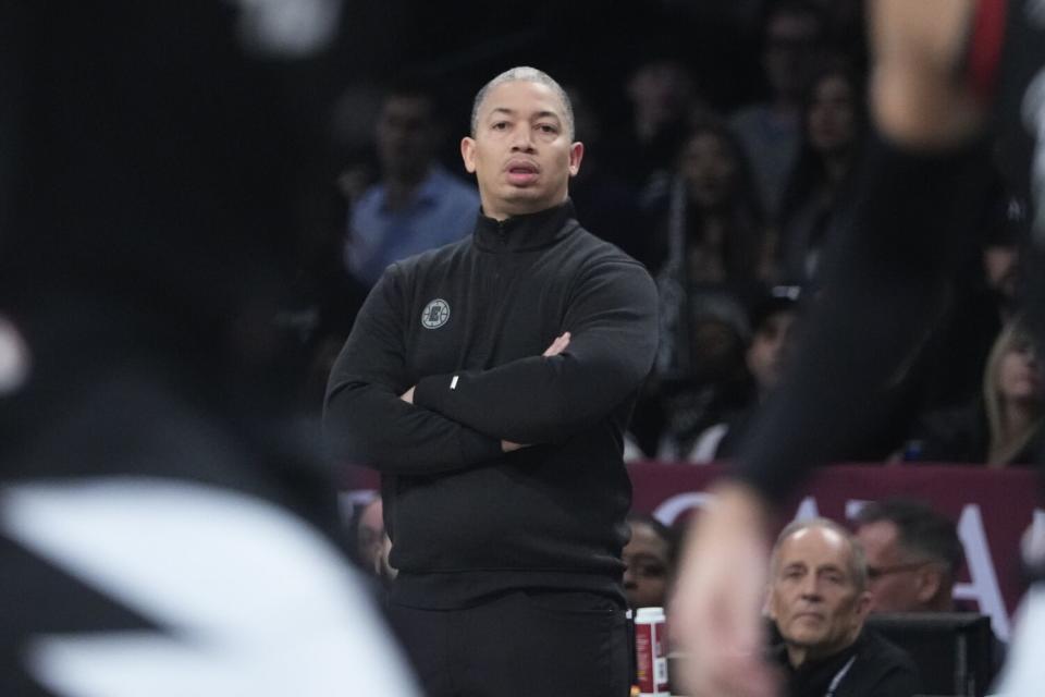 Clippers coach Tyronn Lue stands along the sideline with his arms folded as he watches his team play a game in New York.