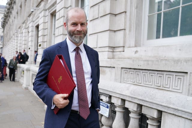 Jonathan Reynolds standing outside with ministerial folder under his right arm