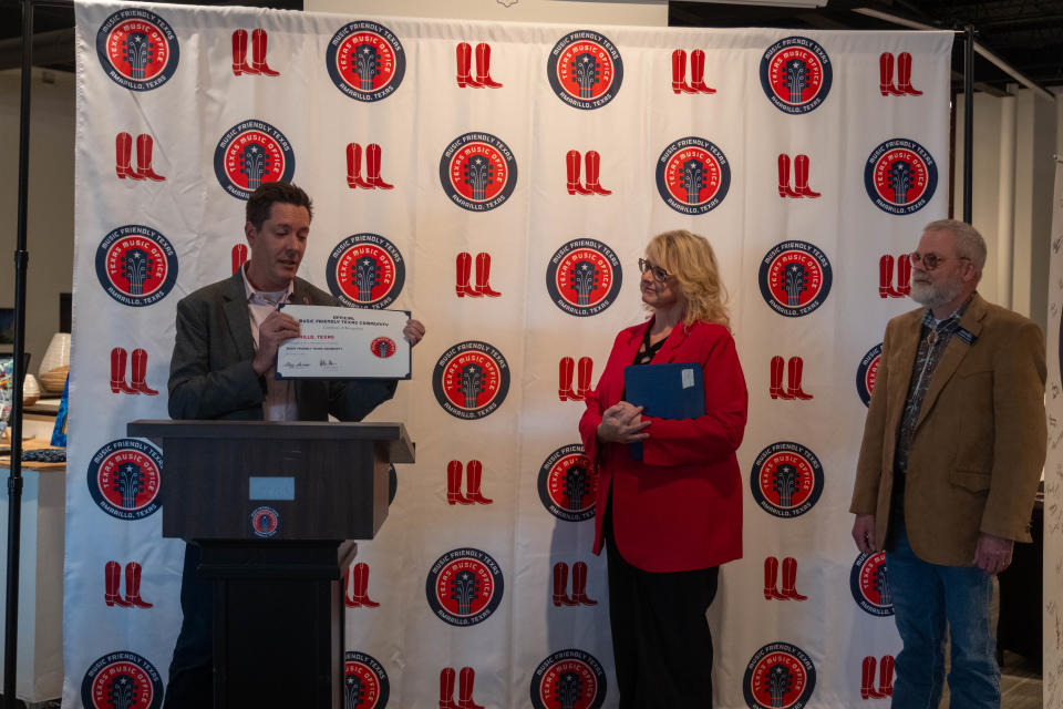 Chip Adams, the community relations and outreach specialist for the Texas Music Office, presents the "Music Friendly Texas Community" designation to Amarillo Monday at Arts in the Sunset in Amarillo.