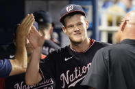 Washington Nationals' pitcher Josh Rogers is congratulated by his teammates after pitching eight inning of a baseball game against the Miami Marlins, Tuesday, Sept. 21, 2021, in Miami. The Nationals defeated the Marlins 7-1. (AP Photo/Marta Lavandier)