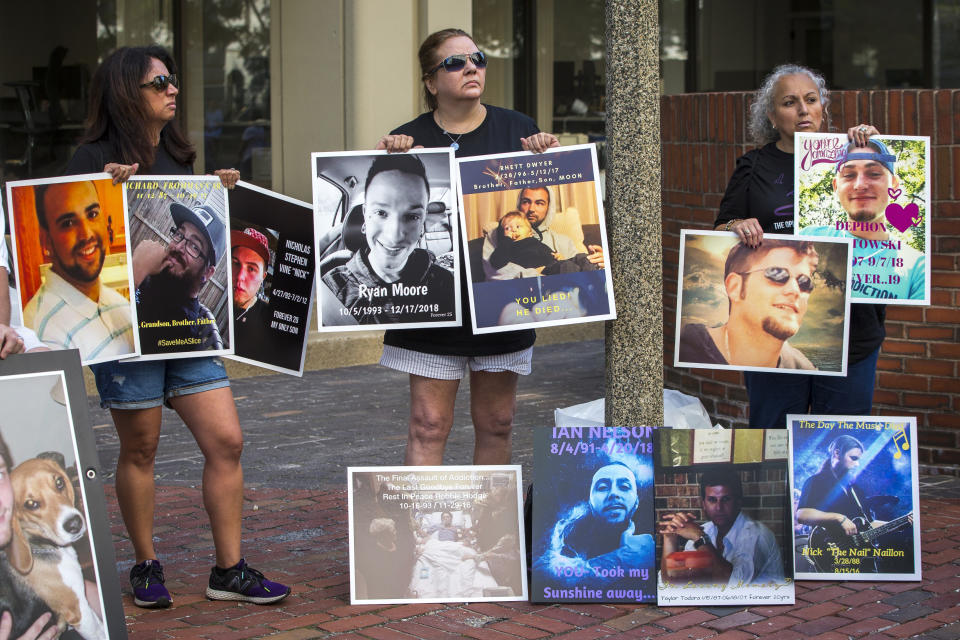 BOSTON, MA - AUGUST 2: Protesters hold signs outside of the Suffolk County Superior Court in Boston on Aug. 2, 2019. Friends and family of opioid overdose victims gathered outside of the steps of the Suffolk County Superior Court while a lawsuit against Purdue Pharma was underway inside. OxyContin maker Purdue Pharma on Friday sought to minimize its role both in the opioid addiction crisis and as a player in the painkiller industry as it asked a Massachusetts judge to dismiss a lawsuit from the state. (Photo by Nic Antaya for The Boston Globe via Getty Images)