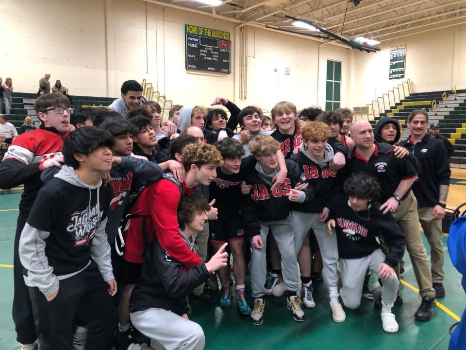 The Jackson Memorial High School wrestling team celebrates after it win the NJSIAA Central Group 4 championship Wednesday night at Brick Memorial.