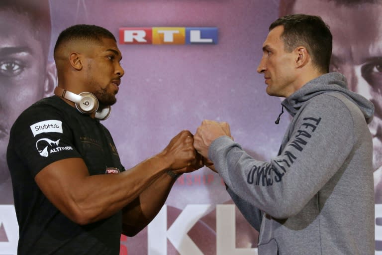 Britain's Anthony Joshua (L) sizes up Ukraine's Wladimir Klitschko during a joint press conference in London on April 27, 2017 ahead of their IBF, IBO and WBA Super, world Heavyweight title fight at Wembley Stadium