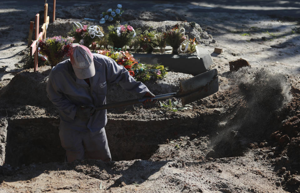 A grave digger prepares graves in the COVID-19 section of the Maitland Cemetery in Cape Town, South Africa, Wednesday, July 15, 2020. For months, the city of Cape Town was the biggest coronavirus hot spot in Africa. Now, finally, there are signs of relief. (AP Photo/Nardus Engelbrecht)