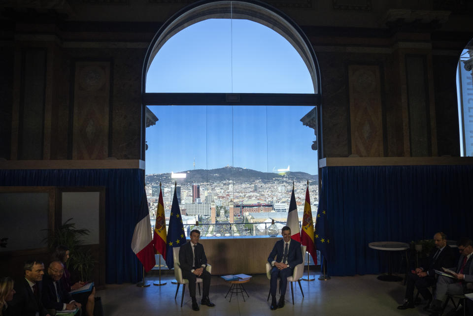 French President Emmanuel Macron, left, talks with Spanish counterpart Pedro Sánchez in Barcelona, Spain, on Thursday, Jan. 19, 2023. A summit between the Spanish and French governments, led by their executive leaders, prime minister Pedro Sánchez and president Emmanuel Macron, is held in the capital of Catalonia to strengthen relations between the European neighbors by signing a friendship treaty. (AP Photo/Emilio Morenatti)