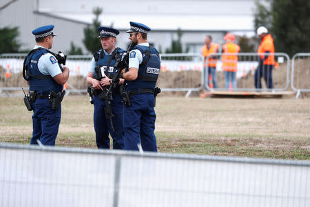 Security checks are conducted during grave digging ceremony for victims of Friday's shooting, at Memorial Park Cemetery in Christchurch, New Zealand March 18, 2019. REUTERS/Edgar Su