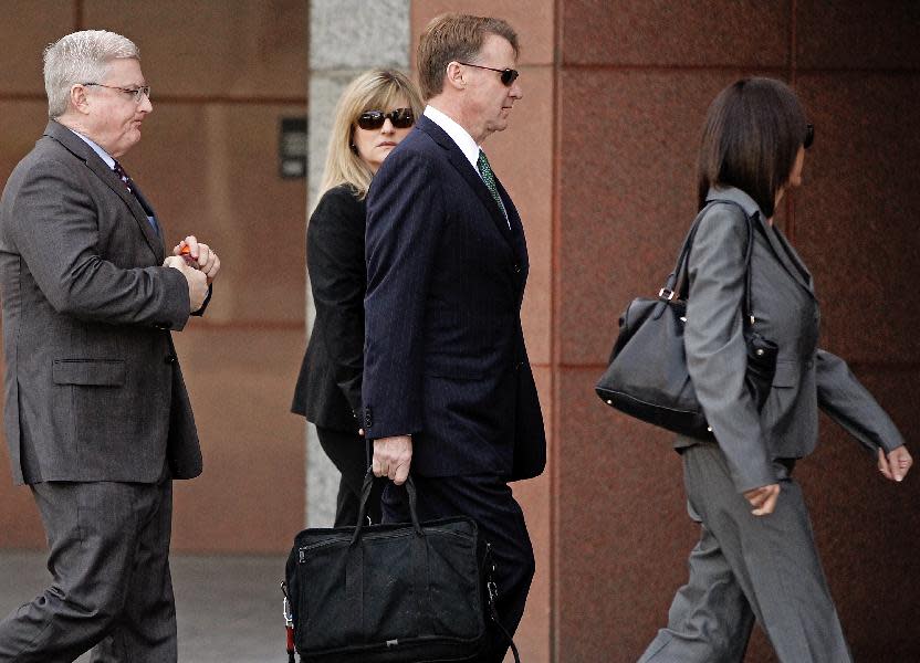 Former Deutsche Bank executive Brian Mulligan, center, arrives with his wife Victoria, second from left, with unidentified attorneys, at the Edward R. Roybal Federal Building, Tuesday, Jan. 21, 2014, in Los Angeles. A trial began for Mulligan, who sued the city of Los Angeles and two police officers claiming they beat him during a bizarre incident in May 2012. He is seeking $20 million in damages in a lawsuit filed in federal court. Officers said Mulligan told them he had ingested a type of bath salts known as White Lightning. Mulligan, who has no prior criminal record, once served as co-chairman of Universal Studios and chief financial officer of Seagram Co. (AP Photo/Damian Dovarganes)