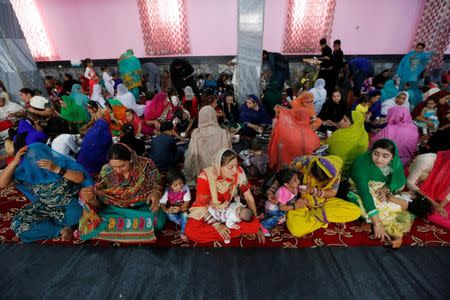 Afghan Hindu and Sikh families wait for lunch inside a Gurudwara, or a Sikh temple, during a religious ceremony in Kabul, Afghanistan June 8, 2016. REUTERS/Mohammad Ismail