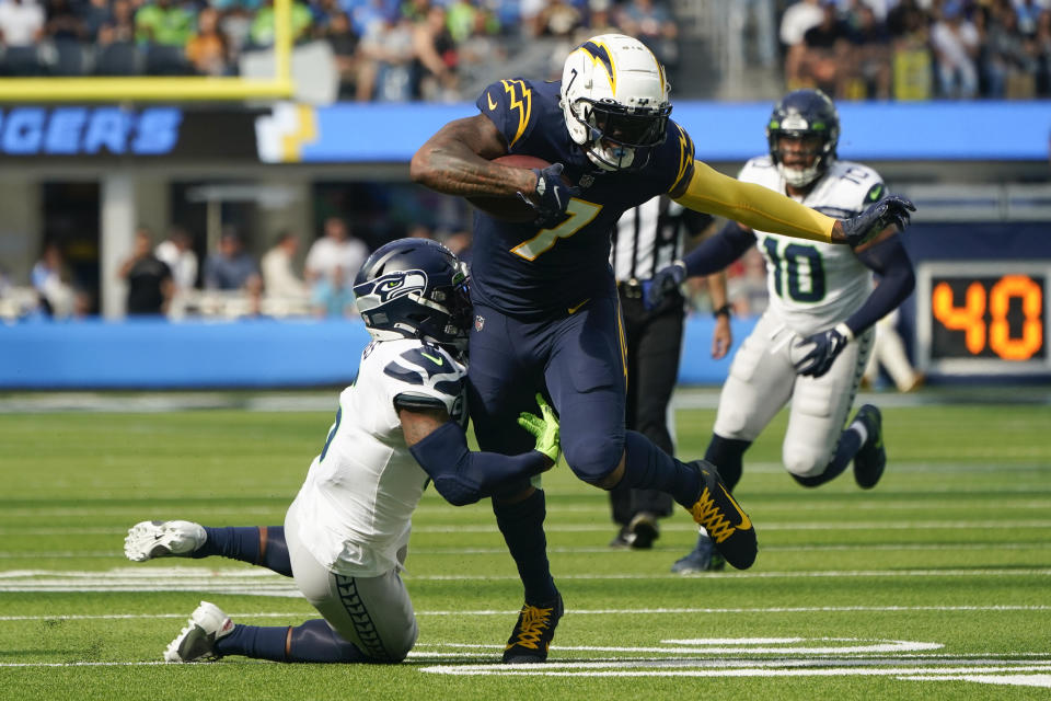 Los Angeles Chargers tight end Gerald Everett (7) runs the ball against Seattle Seahawks safety Quandre Diggs (6) during the first half of an NFL football game Sunday, Oct. 23, 2022, in Inglewood, Calif. (AP Photo/Marcio Jose Sanchez)