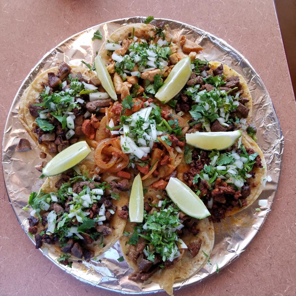 A platter of tacos with chorizo, tripa, lengua, pork al pastor, beef and chicken at Chicken 'n Salsa Mexican Restaurant.