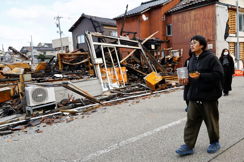 Japanese lacquer artist Kohei Kirimoto searches for his cats, in the aftermath of an earthquake, in Wajima