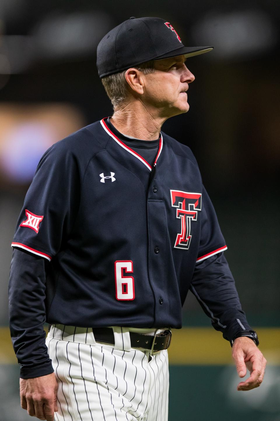 Texas Tech head coach Tim Tadlock walks off the field against Michigan during the State Farm College Baseball Showdown on Friday, Feb. 18, 2022, at Globe Life Field in Arlington, Texas.
