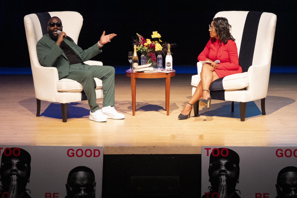 Rick Ross talks with Professor Moraima "Mo" Ivory during the final night of a Gerogia State University class called Legal Life of Rick Ross in Atlanta on Tuesday, Nov. 7, 2023. (AP Photo/Ben Gray)