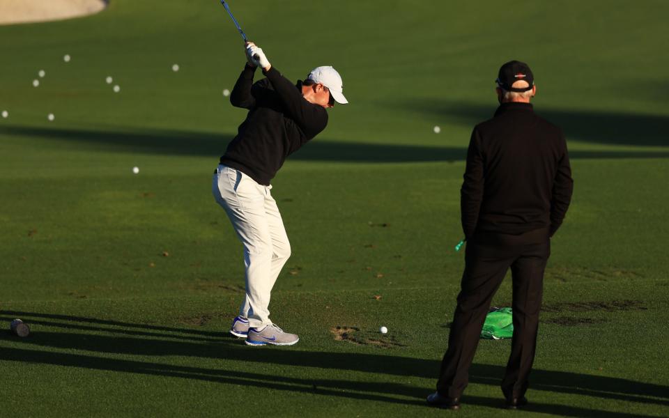 Pete Cowen working with Rory McIlroy at Augusta National in April - GETTY IMAGES