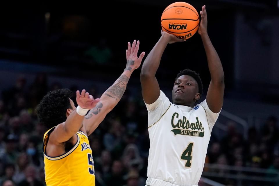 Colorado State guard Isaiah Stevens (4) shoots over Michigan's Eli Brooks, left, during a March 2022 NCAA Tournament game in Indianapolis.