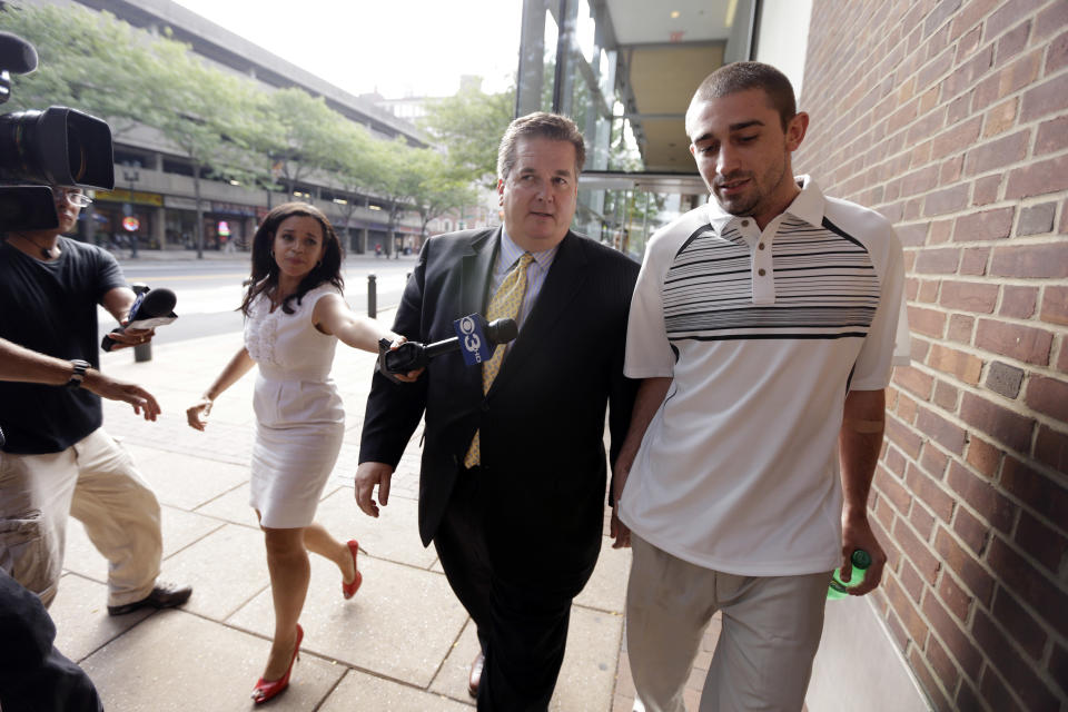 Kenneth W. Smith Jr., right, accompanied by his lawyer Bill Brennan walks near the U.S. Courthouse, Friday, Sept. 7, 2012, in Philadelphia. Smith was arrested and is charged with making a hoax threat that led authorities to recall a plane in midair to the Philadelphia airport. Federal authorities charged 26-year-old Smith Jr. with conveying false and misleading information. According to a criminal complaint, Smith called police at the airport on Thursday, Sept. 6, 2012 and falsely reported a passenger was carrying an explosive substance. Authorities then recalled a Dallas-bound US Airways flight to Philadelphia. (AP Photo/Matt Rourke)
