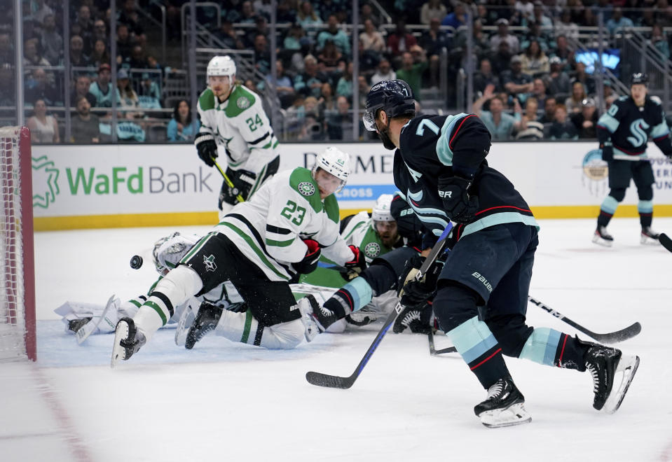 Seattle Kraken right wing Jordan Eberle (7) scores as Dallas Stars center Roope Hintz (24) and defenseman Esa Lindell (23) watch during the first period of Game 6 of an NHL hockey Stanley Cup second-round playoff series Saturday, May 13, 2023, in Seattle. (AP Photo/Lindsey Wasson)