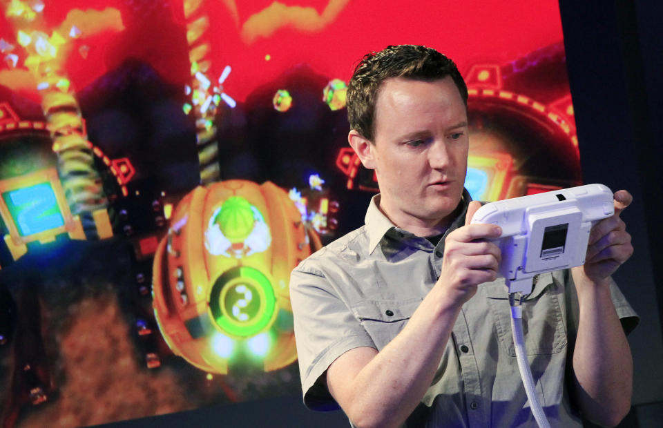 Nintendo's Bill Trinen demonstrates the Wii U GamePad, Thursday, Sept. 13, 2012 in New York. The gaming console will start at $300 and go on sale in the U.S. on Nov. 18, in time for the holidays, the company said Thursday. (AP Photo/Mark Lennihan)