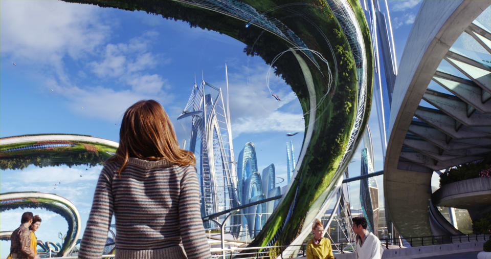 A girl looking up at a futuristic city in "Tomorrowland"