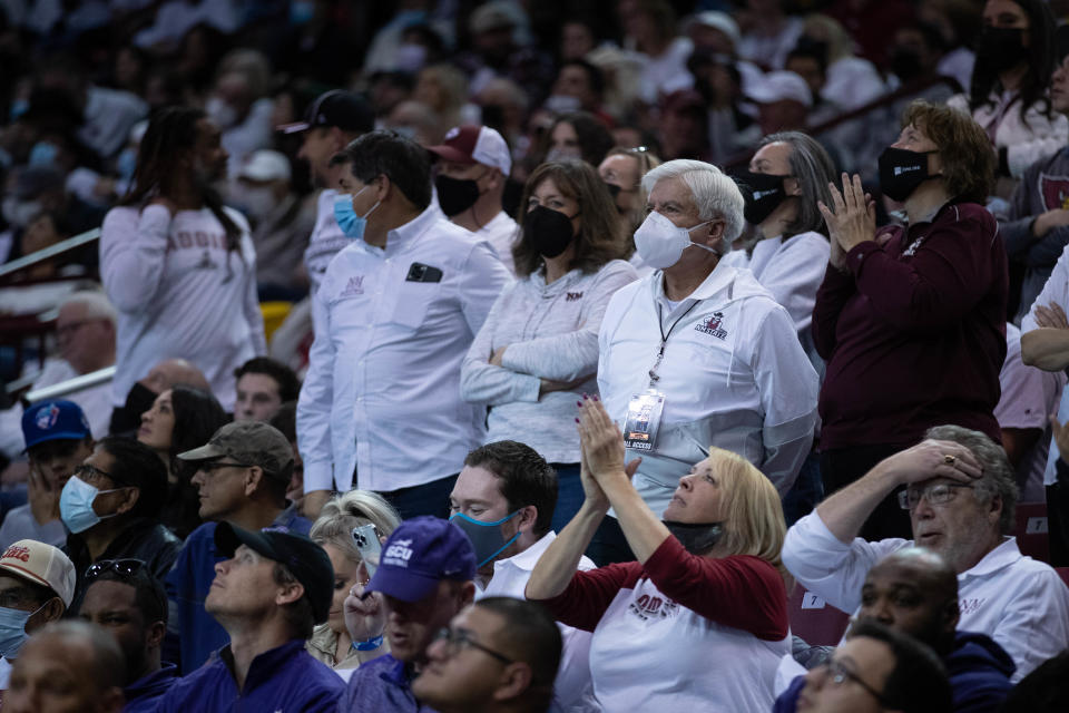 Fans — including New Mexico State University Chancellor Dan Arvizu, in white mask — fill the stands as the New Mexico State Aggies face off against the Grand Canyon Lopes at the Pan American Center in Las Cruces on Saturday, Jan. 29, 2022.