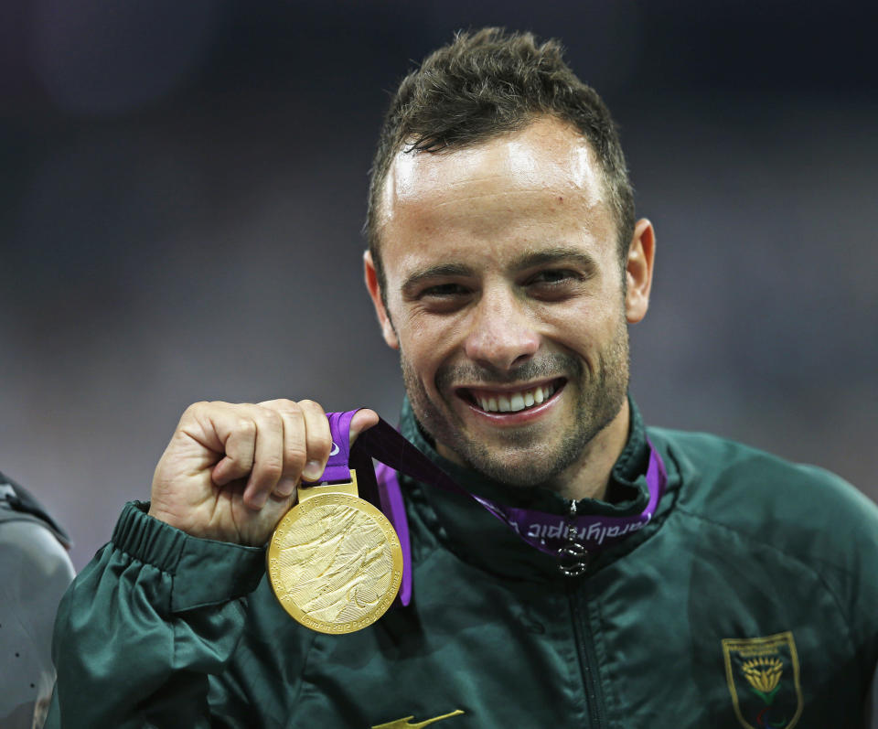 South Africa's Oscar Pistorius celebrates with his gold medal after winning the men's 400m T44 classification at the Olympic Stadium during the London 2012 Paralympic Games September 8, 2012. REUTERS/Eddie Keogh (BRITAIN - Tags: SPORT OLYMPICS ATHLETICS HEADSHOT) - RTR37PDE