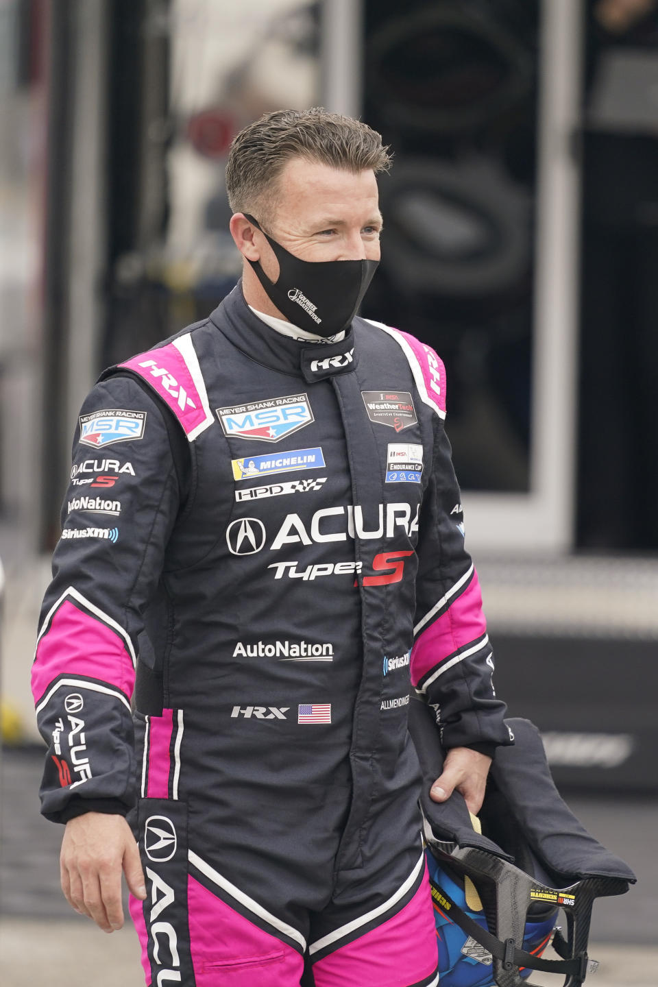 AJ Allmendinger walks back to his garage after a practice session for the Rolex 24 hour auto race at Daytona International Speedway, Saturday, Jan. 23, 2021, in Daytona Beach, Fla. (AP Photo/John Raoux)