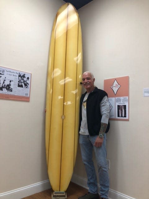 Indialantic’s Bill Whiddon, who began to surf in 1964 on Miami’s South Beach, shows off a classic 9-8 Surfboards Miami longboard. The “Surfing Miami” exhibit at the Florida Surf Museum in Cocoa Beach is on display through March with a grand opening celebration from 7-9 p.m. on Dec. 11.