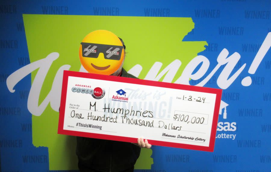 M. Humphries with his $100,000 claim in the Arkansas Scholarship Lottery, Jan. 3, 2024 (courtesy ASL)