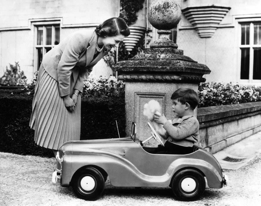 Elizabeth plays with her three-year-old son Charles at Balmoral in Scotland in the fall of 1952.