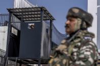 Paramilitary soldiers stand guard outside the first multiplex cinema of Kashmir in Srinagar, Indian controlled Kashmir, Friday, Sept. 30, 2022. The multi-screen cinema hall has opened in the main city of Indian-controlled Kashmir for public for the first time in 14 years. The 520-seat hall with three screens opened on Saturday, Oct. 1, amid elaborate security but only about a dozen viewers lined up for the first morning show. (AP Photo/Dar Yasin)