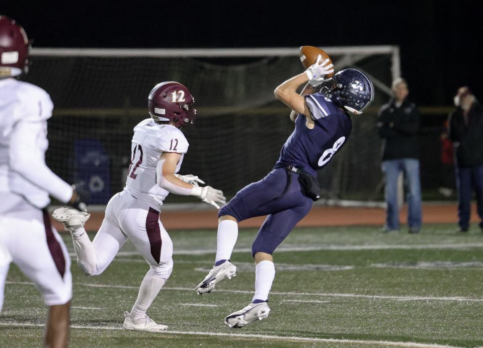 Hudson wide receiver Colin Pierce makes a leaping catch durign the Explorers' 23-14 home playoff loss to Walsh Jesuit Friday.