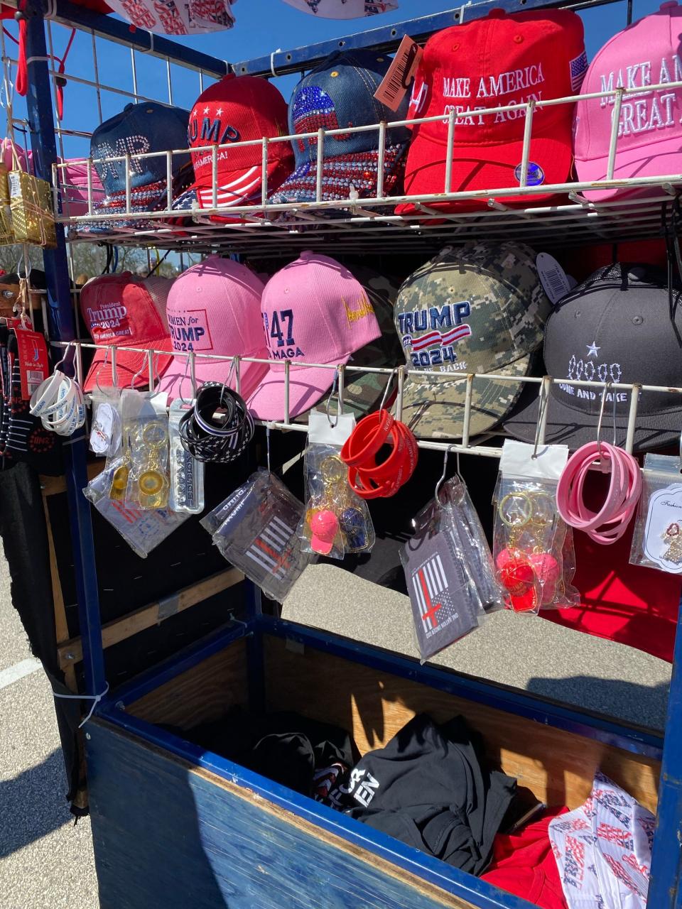 Hats, keychains, bracelets and more are sold as merchandise outside the Trump rally in Waukesha.