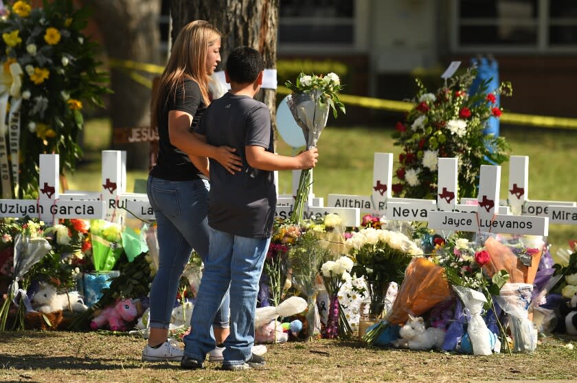 Uvalde, Texas May 26, 2022- Family members place flowers at a memorial outside Rob Elementary School in Uvalde, Texas. Nineteen students and two teachers died when a gunman opened fire in a classroom Tuesday. (Wally Skalij/Los Angeles Times)
