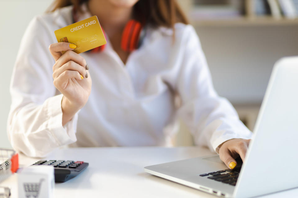 Woman shopping online with a credit card