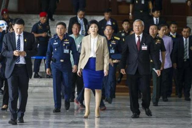 Thailand's Prime Minister Yingluck Shinawatra (C) leaves the Royal Thai Air Force headquarters after a cabinet meeting in Bangkok February 25, 2014. (Reuters file photo)