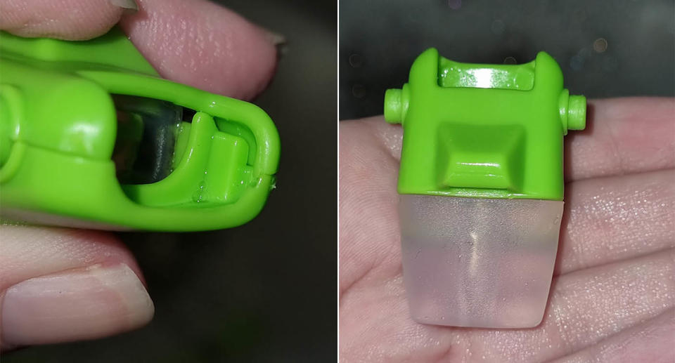 Green spout  from a water bottle which has mould near the top.