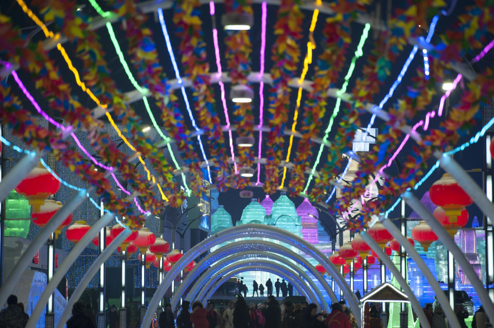 <p>Tourists visit illuminated ice sculptures at Ice and Snow World park on Jan. 4 in Harbin, China. (Photo: Tao Zhang/Getty Images) </p>