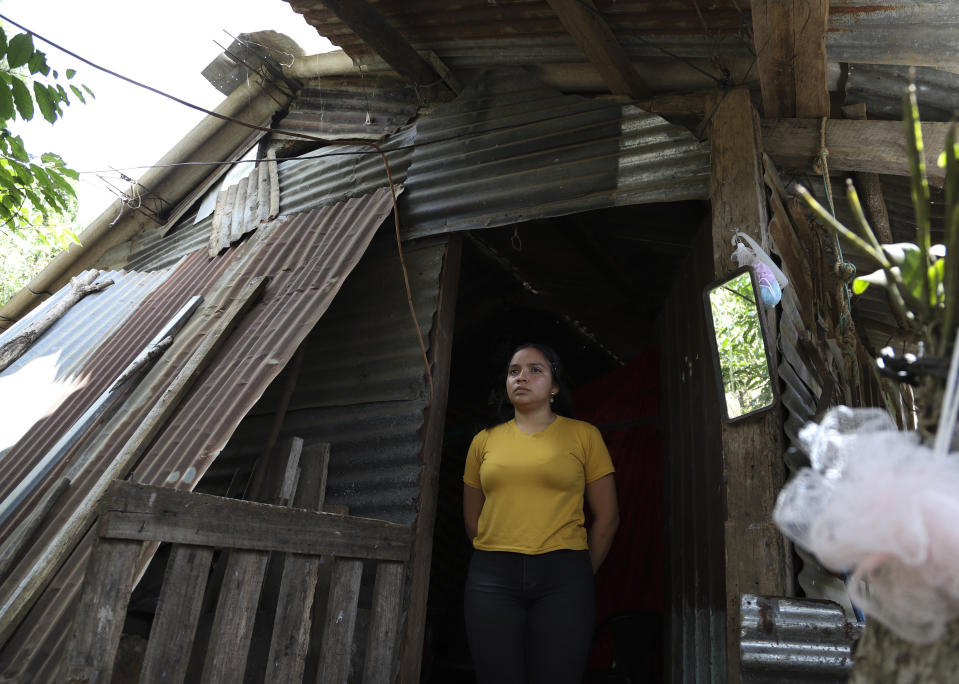 Gisel poses for a portrait at her home in Berlin, El Salvador, Wednesday, March 1, 2023. The teenager and her 8-year-old brother were left without guardians six months prior when police came for her parents after receiving an anonymous tip during the government's "state of exception" that targeted alleged gang members. Their aunt arrived from the capital to care for them, giving up her job to do so, and their extended family pools money. (AP Photo/Salvador Melendez)