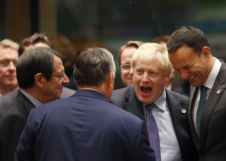 British Prime Minister Boris Johnson, second right, speaks with Irish Prime Minister Leo Varadkar, right, and Hungarian Prime Minister Viktor Orban, center, during a round table meeting at an EU summit in Brussels, Thursday, Oct. 17, 2019. Britain and the European Union reached a new tentative Brexit deal on Thursday, hoping to finally escape the acrimony, divisions and frustration of their three-year divorce battle. (AP Photo/Frank Augstein)