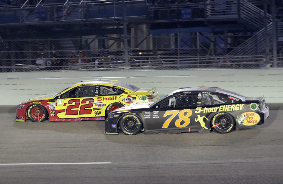 Joey Logano (22) and Martin Truex Jr. (78) drive on the track during the NASCAR Cup Series Championship auto race at the Homestead-Miami Speedway, Sunday, Nov. 18, 2018, in Homestead, Fla. (AP Photo/Lynne Sladky)