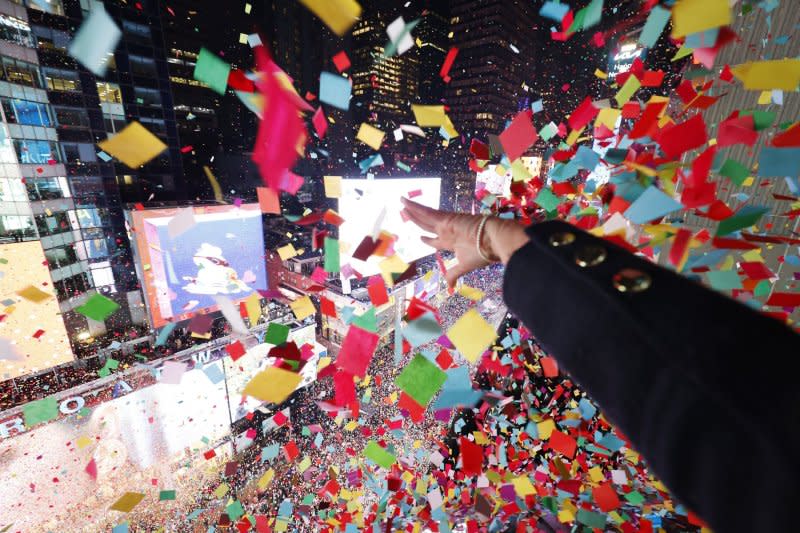 A worker releases confetti at midnight in Times Square for the New Year's Eve celebrations in New York City on Monday. Photo by John Angelillo/UPI