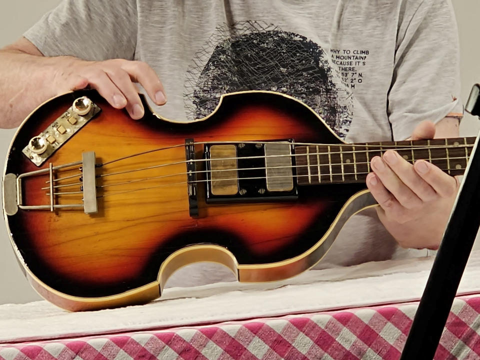 A man shows Paul McCartney's Beatles bass guitar after it was found and returned after 51 years, in an unknown location, United Kingdom, 2023, in this handout image obtained by Reuters on February 16, 2024. Nick Wass/The Lost Bass Project/Handout via REUTERS    THIS IMAGE HAS BEEN SUPPLIED BY A THIRD PARTY NO RESALES. NO ARCHIVES. MANDATORY CREDIT