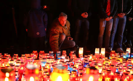 Bosnian Croats pray and light candles for the convicted general Slobodan Praljak, who killed himself seconds after the verdict in the U.N. war crimes tribunal in The Hague, in Mostar, Bosnia and Herzegovina November 29, 2017. REUTERS/Dado Ruvic