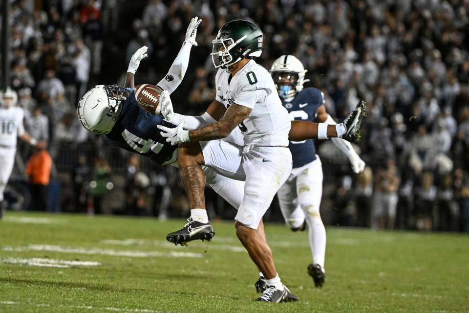 Penn State cornerback Kalen King (4) breaks up a pass intended for Michigan State wide receiver Keon Coleman (0) during the first half of an NCAA college football game, Saturday, Nov. 26, 2022, in State College, Pa. (AP Photo/Barry Reeger)