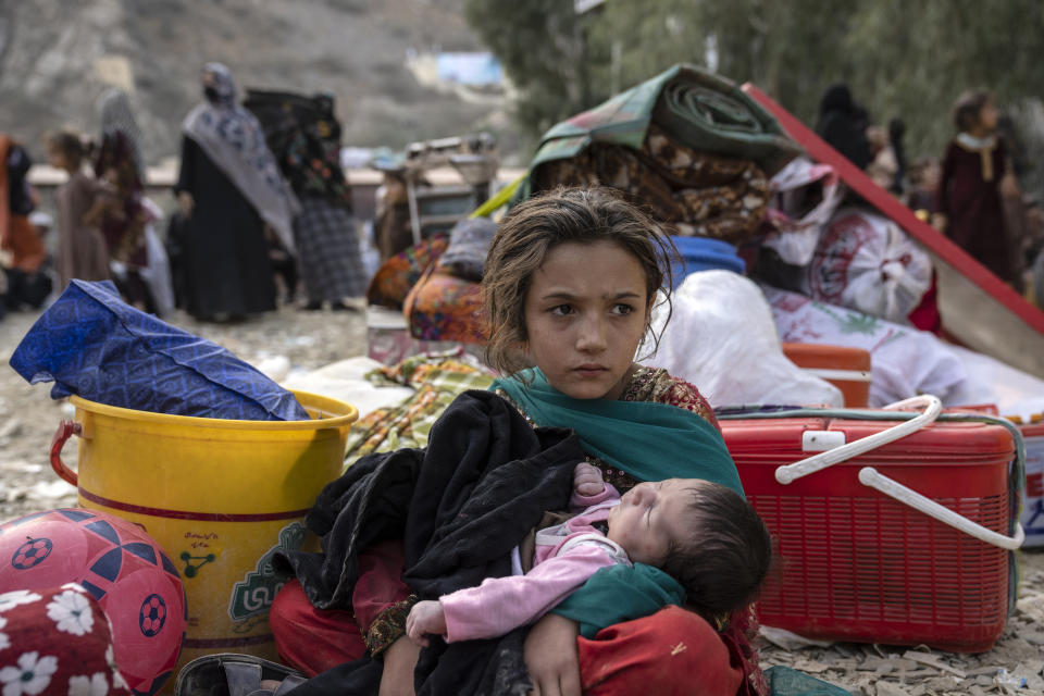 Afghan refugees wait at the Torkham Pakistan-Afghanistan border to be transferred to a camp near the border, in Torkham, Afghanistan, Friday, Nov. 3, 2023. A huge number of Afghan refugees entered the Torkham border to return home hours before the expiration of a Pakistani government deadline for those who are in the country illegally to leave or face deportation. (AP Photo/Ebrahim Noroozi)