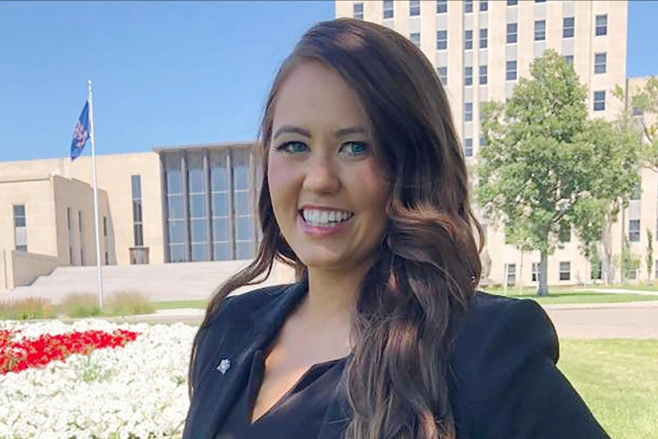 FILE - Cara Mund poses for a photo in front of the state Capitol in Bismarck, N.D. on Aug. 10, 2022. Mund is running for a Congressional seat in the Nov. 8 election. (AP Photo/James MacPherson, File)