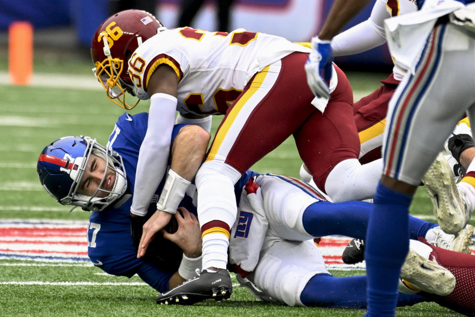 New York Giants quarterback Jake Fromm (17) is sacked by Washington Football Team cornerback Danny Johnson during the first quarter of an NFL football game, Saturday, Jan. 9, 2021, in East Rutherford, N.J. (AP Photo/Bill Kostroun)